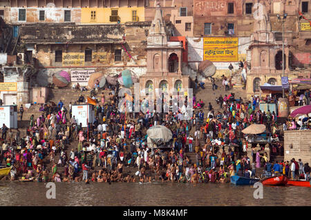 VARANASI, INDIA. February 28, 2017: Crowds of people the stairs of the embankment of the river Ganges, Varanasi, India. Hindus brush their teeth washe Stock Photo