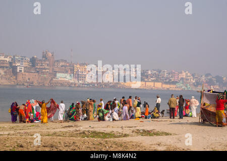 VARANASI, INDIA. February 28, 2017: Women - Indian women wash and bathe on the opposite Bank of the Ganges from Varanasi. Stock Photo