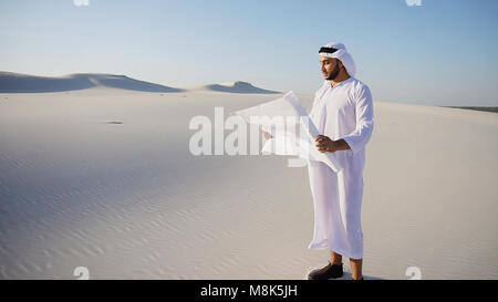 Serious young Arabian UAE Sheikh businessman considering constru Stock Photo
