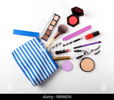 makeup bag with cosmetics on white background. top view Stock Photo