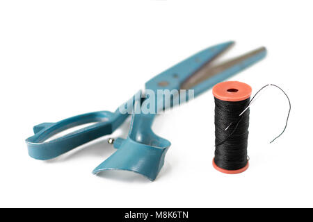 Old vintage sewing scissors and thread bobbin with needle Stock Photo