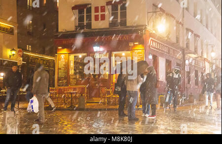 PARIS , France- March 17, 2018: View of typical Parisian cafe Le Consulat during snowfall . It is located at Montmartre area , one of the most popular Stock Photo