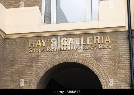 signs at hays galleria in london featuring shops, restaurants, cafe's and bars with stalls of gifts Stock Photo