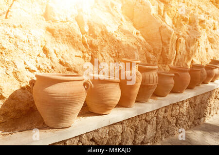 many large clay pots standing in a row outdoor Stock Photo