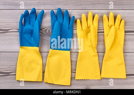 Rubber gloves on wooden background. Stock Photo