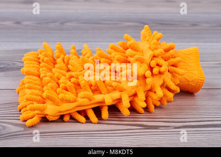 Orange microfiber cleaner glove. Stock Photo