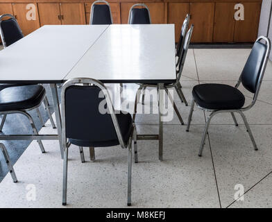 Table and metal chair set for informal conference in the morning before the office hour, outside the office building. Stock Photo