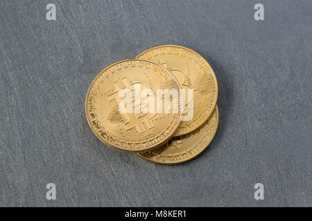 several bitcoins on a plastered surface, top view. electronic money Stock Photo
