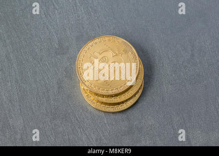 several bitcoins on a plastered surface, top view. electronic money Stock Photo