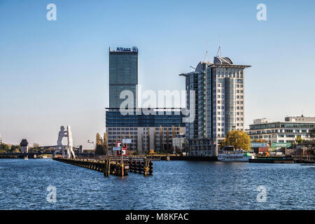 Molecule Man,aluminium sculpture by American artist Jonathan Borofsky in the river Spree-three giant men pierced with holes which represent molecules. Stock Photo