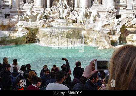 Rome, Italy. February 11, 2017. People taking pictures at the Trevi Fountain on a sunny day (Fontana di Trevi) Stock Photo