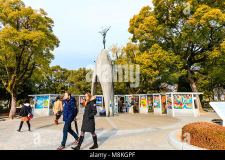 Japan, Hiroshima. People visiting the Children's Peace Memorial to commemorate Sadako Sasaki. Overcast weather. Stock Photo