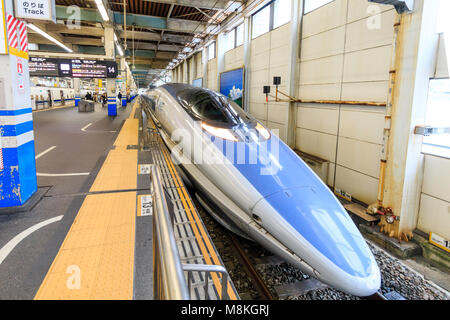 Japan, Hiroshima station. Shinkansen, blue and grey 500 series Kodoma bullet train at platform. Stock Photo