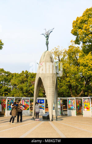 Japan, Hiroshima. People visiting the Children's Peace Memorial to commemorate Sadako Sasaki. Overcast weather. Stock Photo