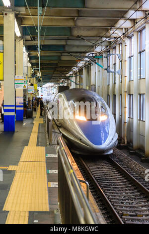 Japan, Hiroshima station. Shinkansen, blue and grey 500 series Kodoma bullet train at platform. Stock Photo