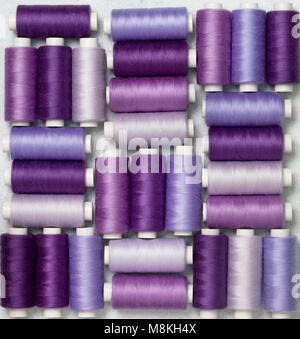 background thread spools purple, violet, lilac close-up. view from above Stock Photo