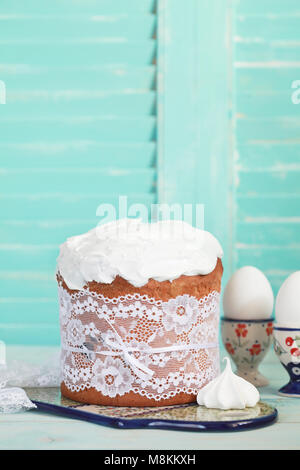 Traditional easter cake with meringue, Kulich, on the wooden table. Selective focus Stock Photo