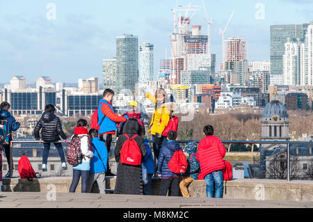 A school party,  at Greenwich Park looking at building work on the Isle of Dogs (oof). Stock Photo