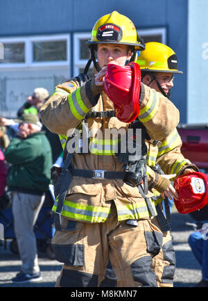 Firemen giving out hats at the Bellingham, Washington, St. Patrick's Day Parade on March 17, 2018. Stock Photo