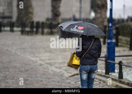 Female in snow storm in London with I love London umbrella. Mini beast from the East wintry weather. Winter. Cold. Tourist. Snowing Stock Photo