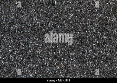 Close-up black  polyurethane foam texture. Rainbow film flares. Abstract black cellular background Stock Photo