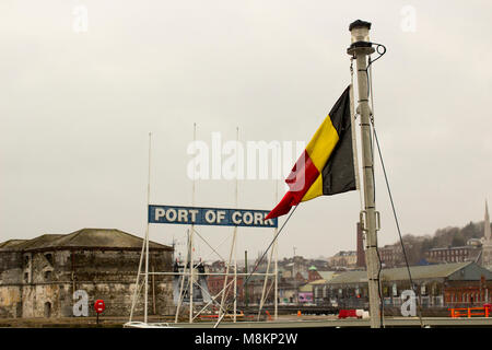 The Belgian National flag flying on the vessel Tridens at Kennedy Wharf in Cork City Harbour during a slight snow storm Stock Photo