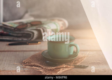 Cups of coffee and newspapers on the old wooden. Stock Photo