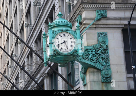 The famous Marshall Fields State St. clocks have been a traditional meeting place in Chicago since they were first installed over 100-years-ago. Stock Photo