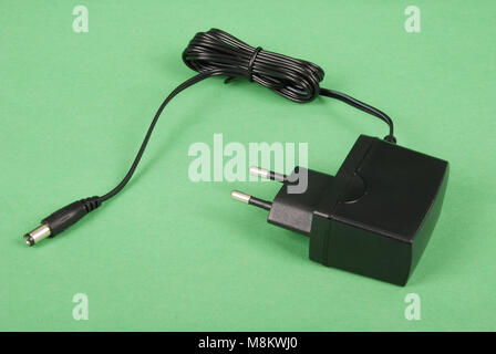 Electric shaver charger isolated on green background Stock Photo