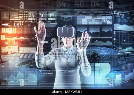 Progressive programmer working in two realities while wearing a special device Stock Photo