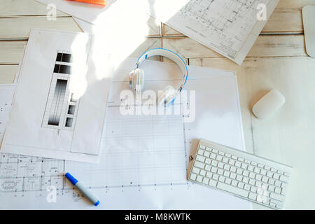 Architectural project, blueprints, blueprint rolls on wooden desk table Stock Photo