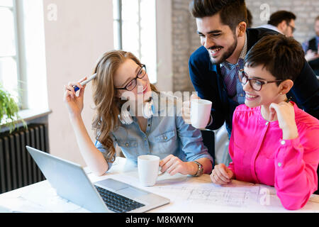 Coworking colleagues having conversation at workplace Stock Photo