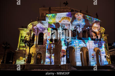18 March 2018, Germany, Frankfurt am Main: Light installation 'Changing Times' on the facade of the old opera, where the front side of the building is being lit up with different scenarios. The illuminations run until 23 March in Frankfurt and Offenbach. Photo: Fabian Sommer/dpa Stock Photo