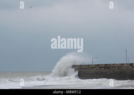 Ramsgate, Kent, UK 18th March, 2018. A large wave hits the harbour arm. Sue Holness Credit: Sue Holness/Alamy Live News Stock Photo