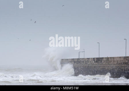 Ramsgate, Kent, UK 18th March, 2018. A large wave crashes into the harbour arm during a snow storm. ue Holness Credit: Sue Holness/Alamy Live News Stock Photo