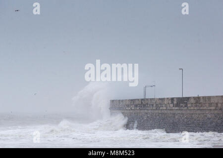 Ramsgate, Kent, UK 18th March, 2018. A large wave crashes into the harbour arm during a snow storm. Sue Holness Credit: Sue Holness/Alamy Live News Stock Photo