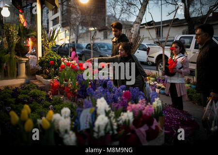 Tehran. 18th Mar, 2018. People buy flowers in Tajrish bazaar in Tehran, Iran, on March 18, 2018, ahead of Nowruz, the Iranian New Year. Nowruz marks the first day of spring and the beginning of the year in Iranian calendar. Credit: Ahmad Halabisaz/Xinhua/Alamy Live News Stock Photo