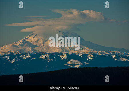 Mt Rainier seen from Mission ridge about 69 miles northeast during winter appears very large because of the relatively low lands surrounding the peak. Stock Photo