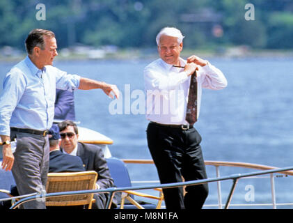 President Boris Yeltsin of the Russian Federation, right, removes his tie as he and United States President George H.W. Bush, left, take a boat ride on the Severn River in Maryland on June 17, 1992.   Credit: Ron Sachs / CNP /MediaPunch Stock Photo