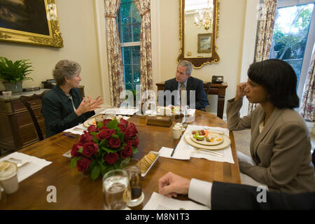 In this handout photo provided by the White House, United States President George W. Bush (C) meets with US Secretary of State Condoleezza Rice (R) and Karen Hughes (L), newly appointed undersecretary of state for public diplomacy, during lunch at the White House October 5, 2005 in Washington, DC.  Mandatory Credit: Eric Draper / White House via CNP /MediaPunch Stock Photo