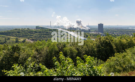 Bottrop, North Rhine-Westphalia, Germany - August 07, 2016: View from Halde Beckstrasse towards the summer toboggan run and the coking plant Stock Photo