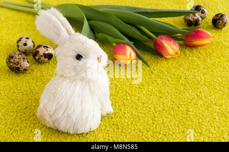 Vibrant colorful easter holiday theme with an easter bunny, tulips and easter eggs. Stock Photo