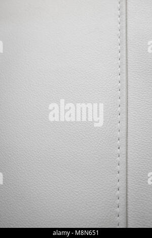 White leather texture with seams in close-up as a background Stock Photo