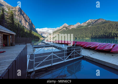 Lake Louise  in morning with Canoes in the Rocky Mountains, Banff National Park, Canada. Stock Photo