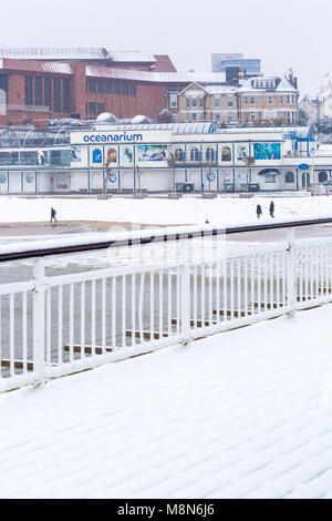 View of Bournemouth beach, Oceanarium, and surrounding area in the snow from Bournemouth Pier at Bournemouth, Dorset, England UK in March Stock Photo