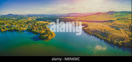 Aerial panorama of beautiful lake and countryside at sunset in Canberra, Australia Stock Photo