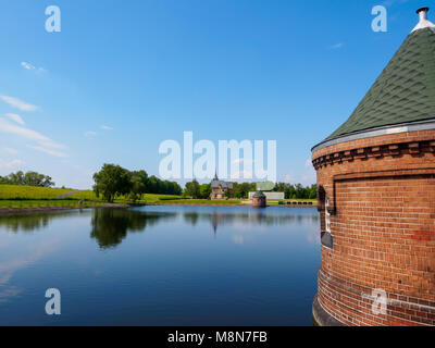 Hamburg, Germany - May 19, 2016: Abandoned control cabins at pond with reflecting watersurface at compound of Industrial museum Wasserkunst Kaltehofe. Stock Photo