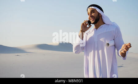 Handsome Muslim Arabian Sheikh architect talking on mobile with  Stock Photo