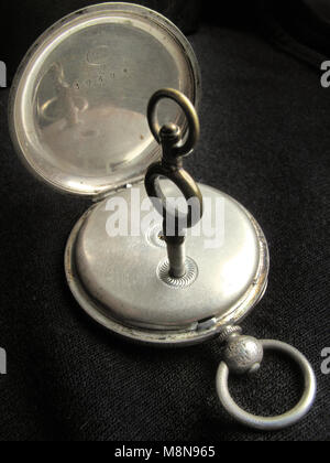 antique pocket watch with winding key Stock Photo