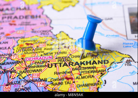 Close view of Pushpin pointing to Uttarakhand on a map of India Stock Photo